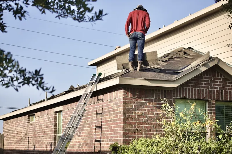 Professional roofer working on a residential roof in Fair Meadow